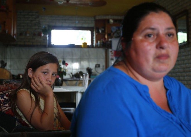 Hungarian public worker Bundi and her daughter sit in their kitchen in Debrecen