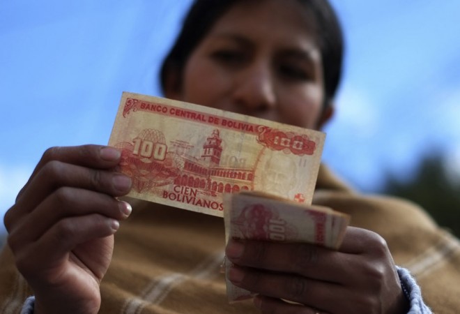 Condori checks her money after receiving her wages in La Paz