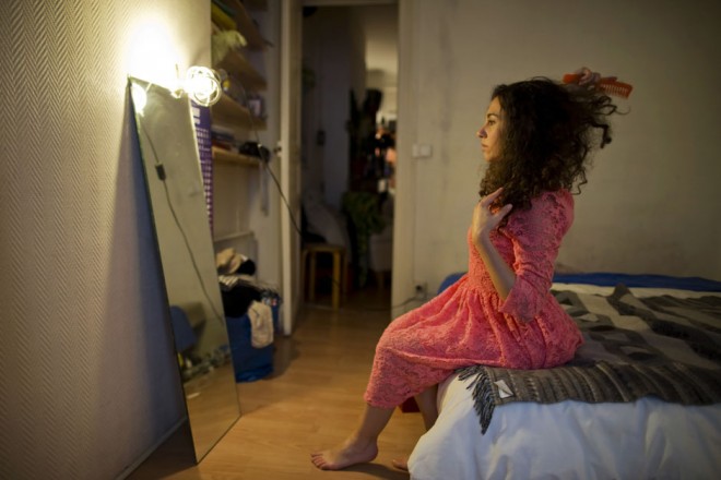 Susanna Dimitri brushes her hair at her apartment in Paris